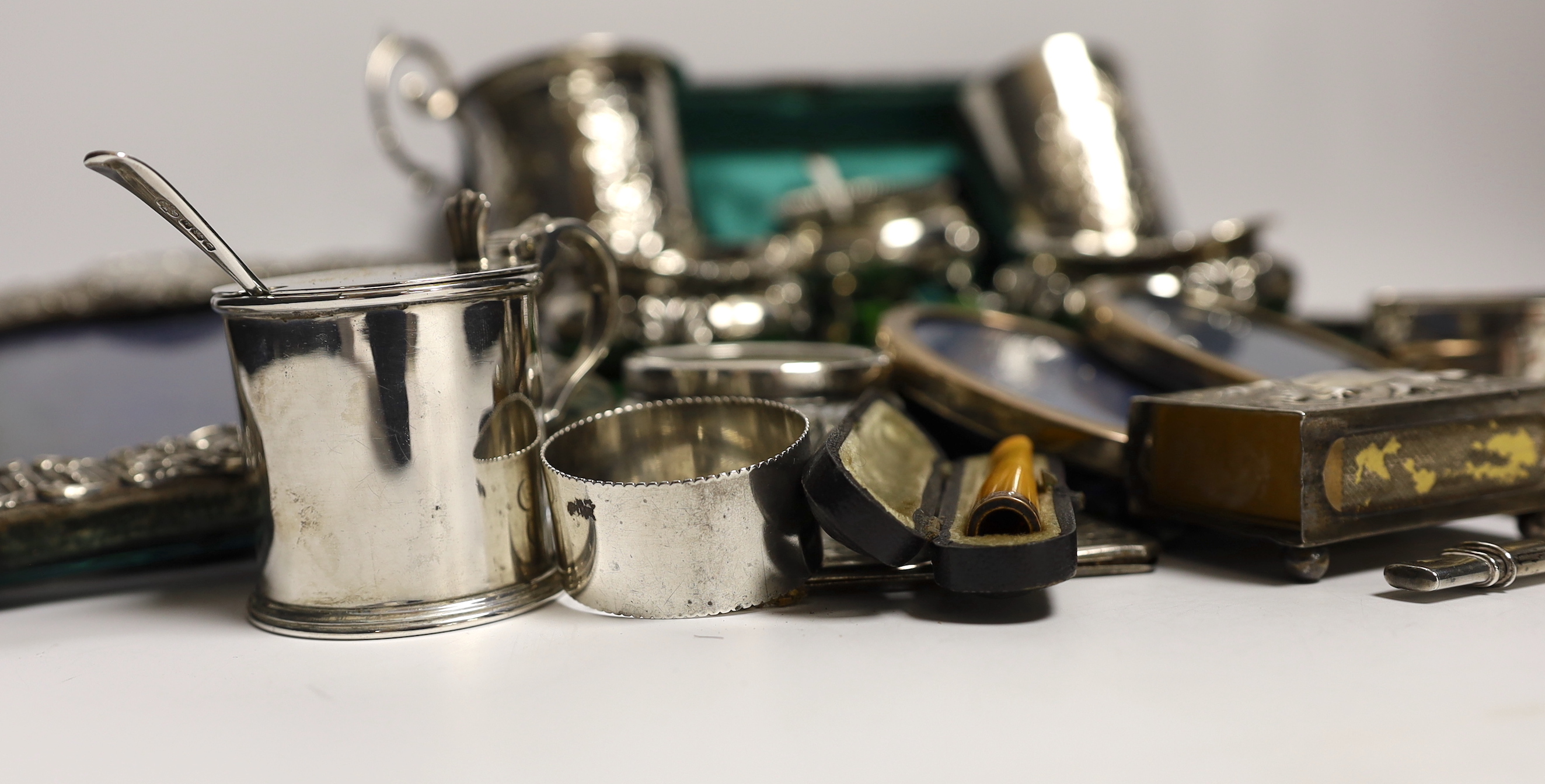 Sundry small silver and white metal items including Edwardian Christening mug, four mounted photograph frames, napkin rings, card cases, bun pepperette etc.